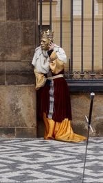 Full length of woman standing on railing