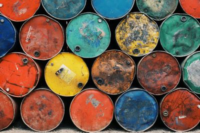 Full frame shot of colorful rusty metallic barrels stack