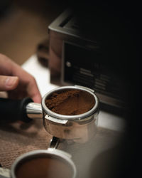 Hand holding coffee cup on table