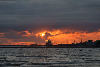 Scenic view of sea against orange sky