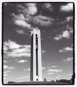 Low angle view of tower against cloudy sky