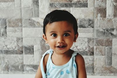 Portrait of cute baby boy sitting at home