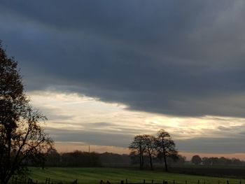 Scenic view of field against sky during sunset