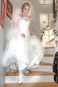 Full length of bride moving down staircase
