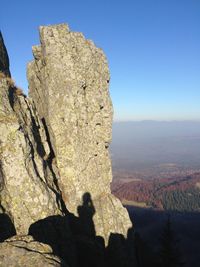 Rock formations on landscape against blue sky