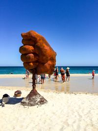 Scenic view of beach against blue sky