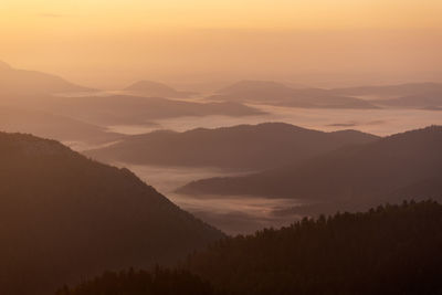 Scenic view of mountains against sky during sunset