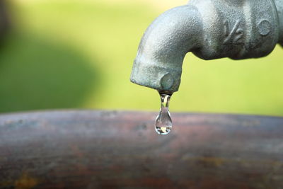 Close-up of water drop from faucet