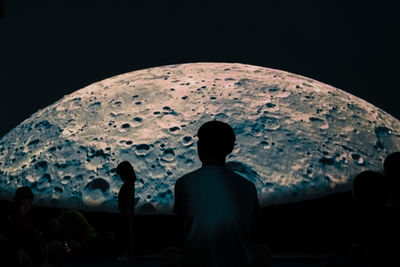 Rear view of silhouette people standing against sky