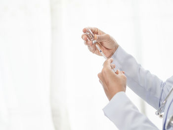 Midsection of woman working in white