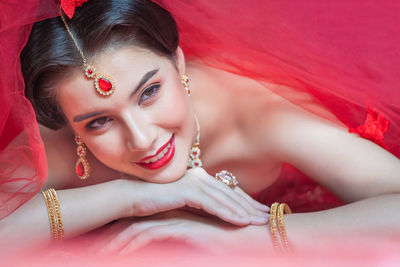 Portrait of a smiling young woman lying down