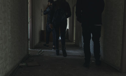 Rear view of people walking in corridor of building