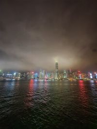 Illuminated city at waterfront