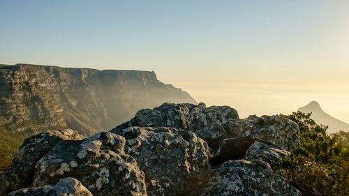 Rock formations against sky during sunset
