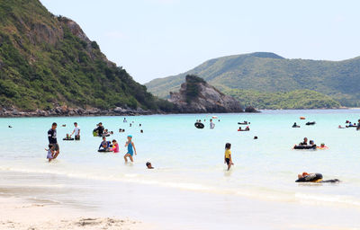 People on beach against sky