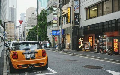 Vehicles on road along buildings