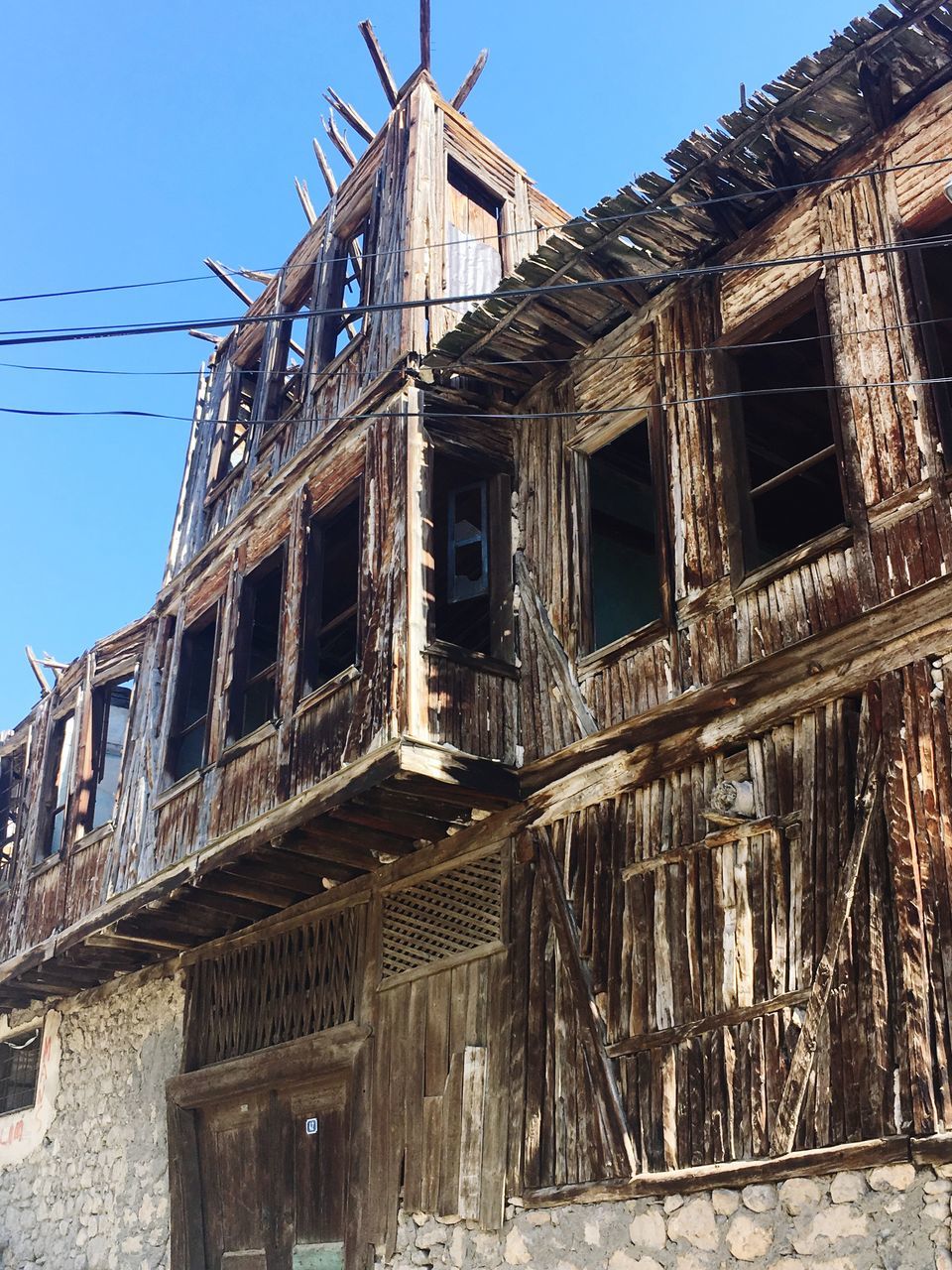 built structure, architecture, low angle view, building exterior, sky, no people, building, abandoned, day, old, nature, clear sky, damaged, obsolete, window, residential district, run-down, weathered, outdoors, construction industry, deterioration, ruined, apartment