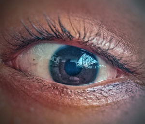 Close-up portrait of woman with blue eye
