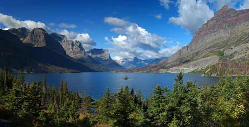 Scenic view of mountains and lake against cloudy sky