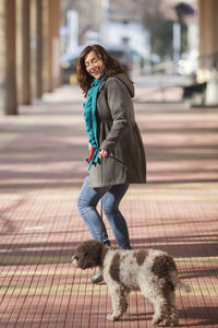 Mature woman with dog in city