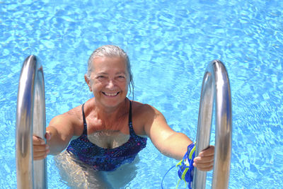 Portrait of senior woman swimming in pool