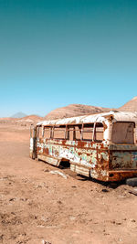 Abandoned truck against clear blue sky