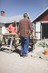 Senior couple doing carpentry at yard