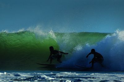 People surfing in sea