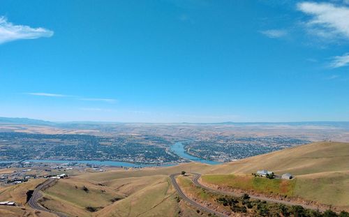 Scenic view of landscape against blue sky