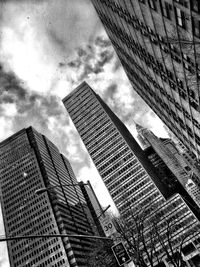 Low angle view of modern building against cloudy sky