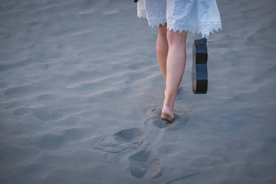 Low section of woman standing on beach