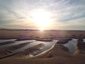 Scenic view of beach against sky during sunset