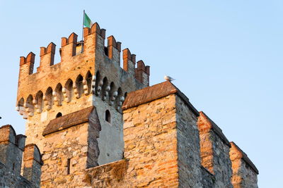 Low angle view of old building against clear sky