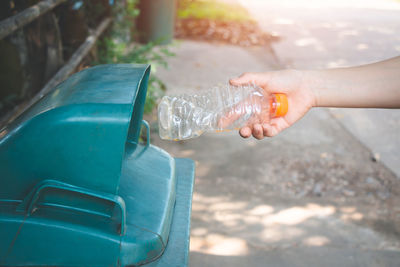 Close-up of hand pouring water from bottle