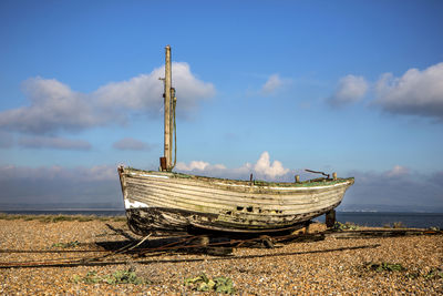 Boat on beach against sky