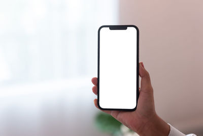 Close-up of hand holding mobile phone