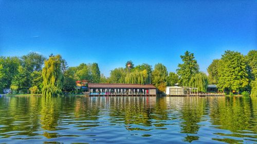 Scenic view of lake against clear blue sky