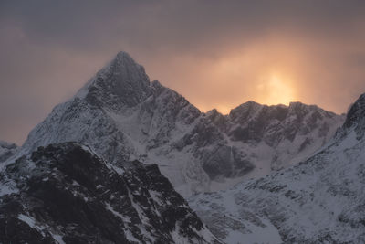 Scenic view of snowcapped mountains against sky during sunset