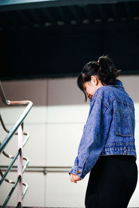 Woman wearing denim standing outdoors