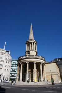 Low angle view of historical building against blue sky