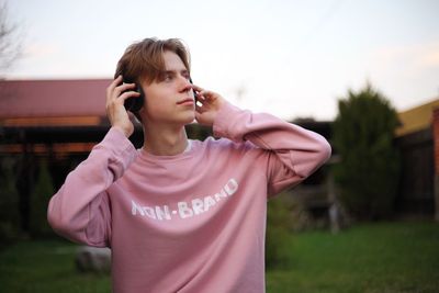 Man looking away while listening music