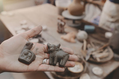 Cropped hand of man holding jigsaw pieces