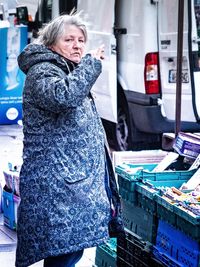 Full length of woman standing in market during winter