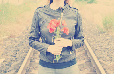 Midsection of woman holding bouquet