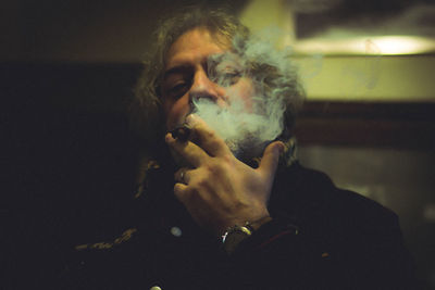 Portrait of man smoking cigar