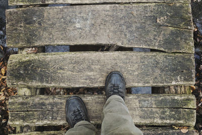 Low section of man standing on cobblestone