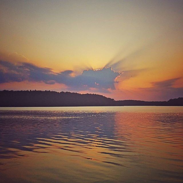 water, sunset, tranquil scene, scenics, waterfront, tranquility, beauty in nature, sky, lake, mountain, reflection, idyllic, nature, silhouette, orange color, sea, cloud - sky, dusk, rippled, cloud