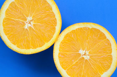 Close-up of orange slice against blue background