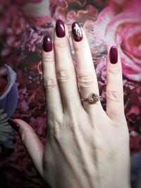 Close-up of woman hand with pink petals