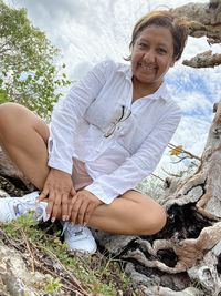 Portrait of a smiling young woman sitting outdoors